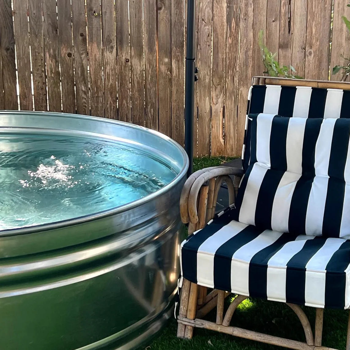A large galvanized steel Stock tank pool DIY kit with sand filtration pump and valves set in a perth backyard 