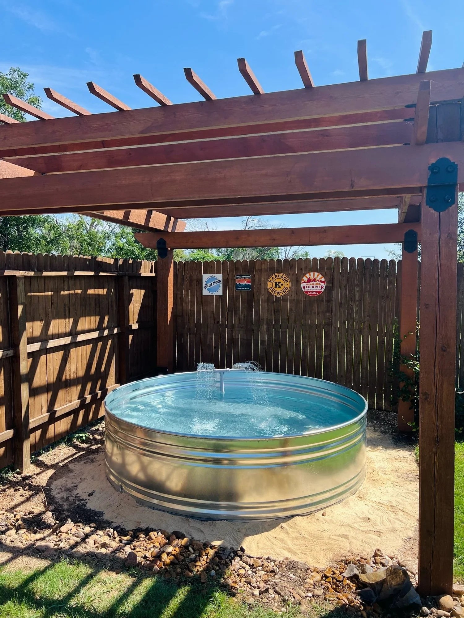 A round galvanized steel stock tank pool with fountain installed by stock tank pools WA in perth 