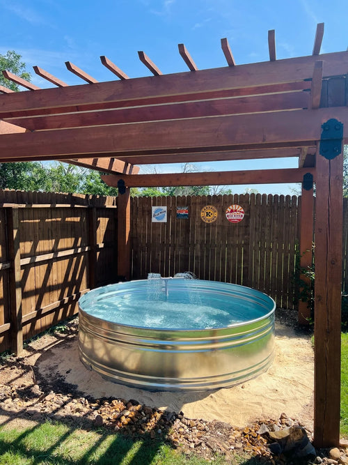 A round galvanized steel stock tank pool with fountain installed by stock tank pools WA in perth 